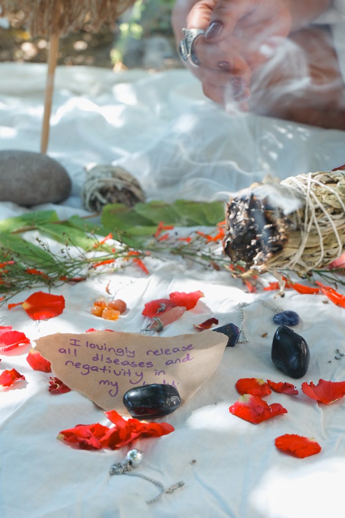 A calming ritual space with burning sage, crystals, and a handwritten note promoting healing energy.
